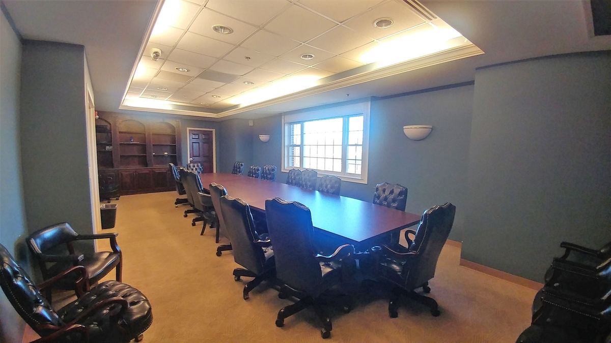 Large conference room with long table and leather chairs