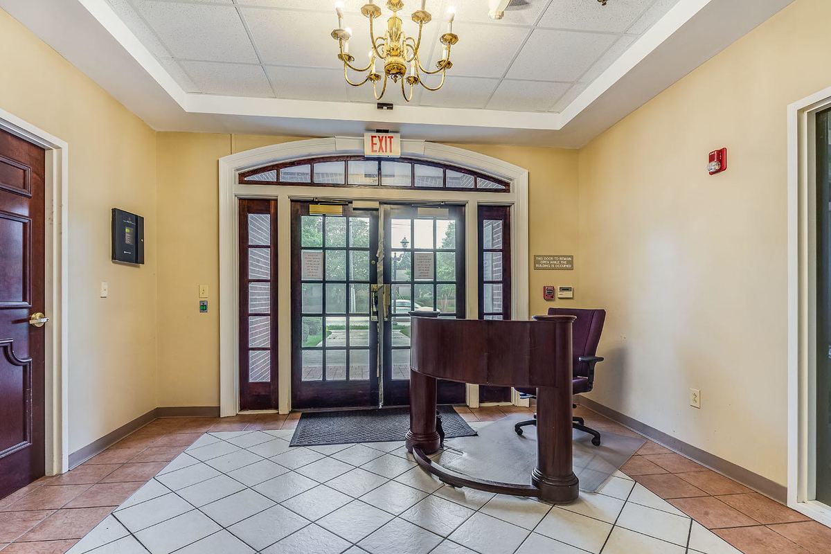 Front lobby with chandelier, tile floor and glass entry doors